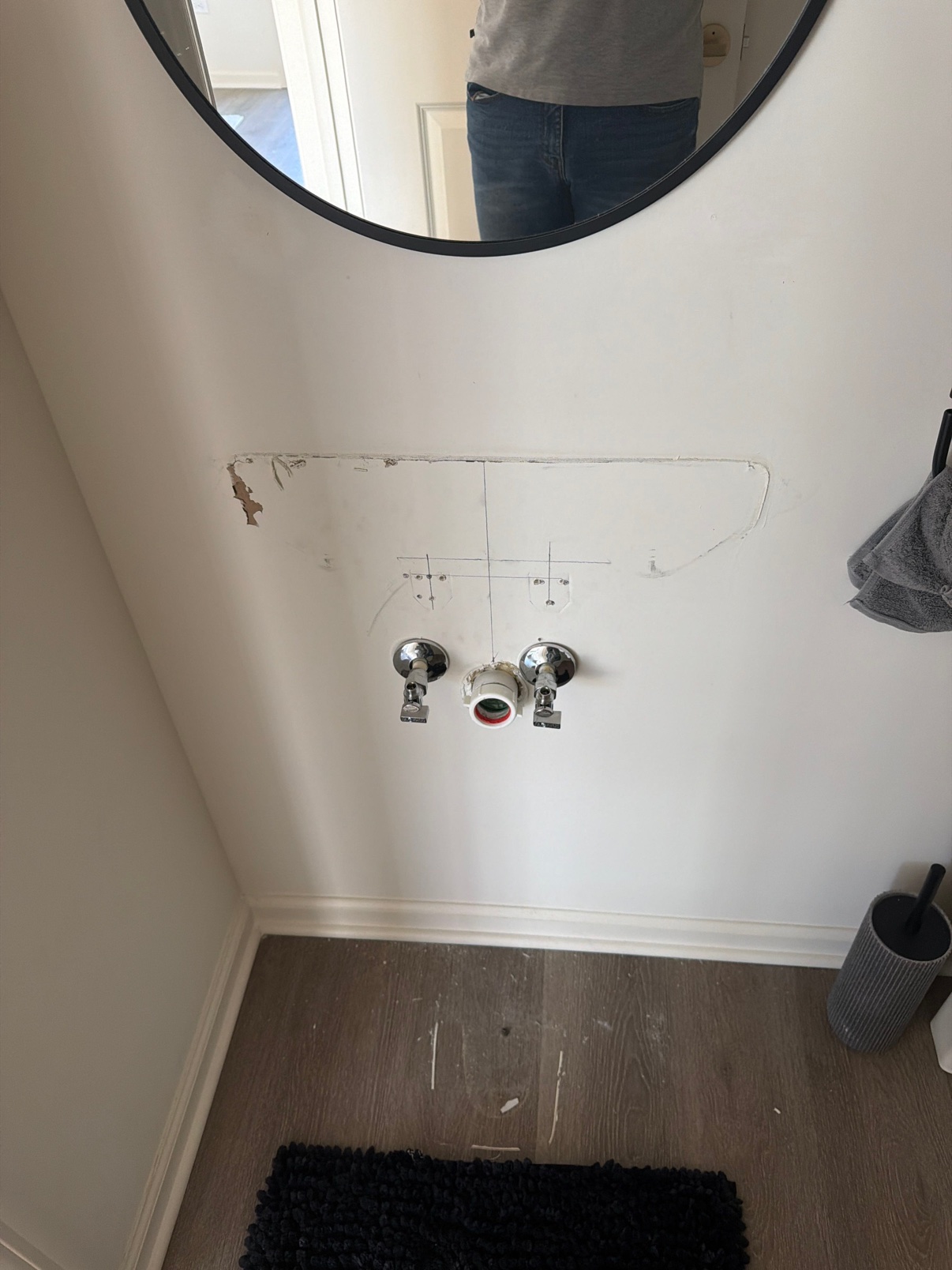 Before: exposed plumbing stub-outs before the vanity was installed