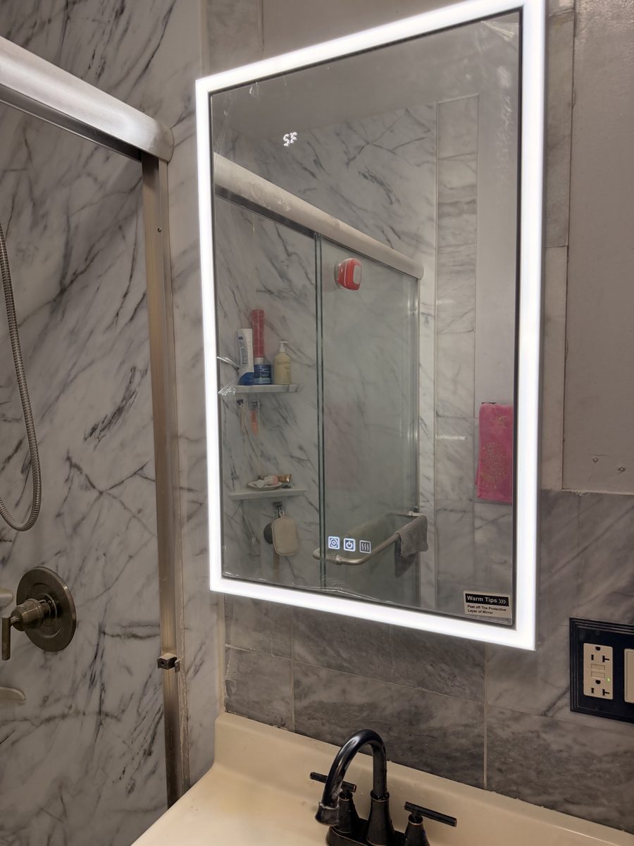 After: new backlit LED mirror over a marble tile wall