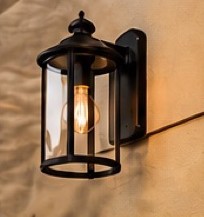Outdoor wall lantern glowing at dusk