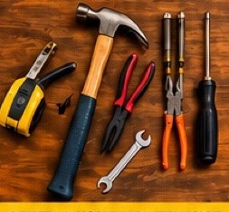 Hand tools on a workbench: hammer, pliers, tape measure, wrenches