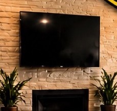 Flat-screen TV mounted above a fireplace